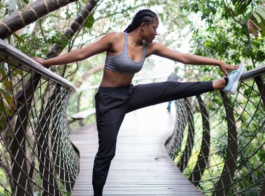 woman stretching outside on a walkway