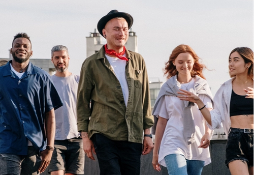 A group of well dressed friends walking on a roof top