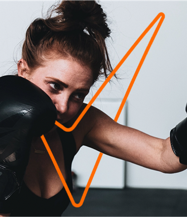 women shadow boxing with black boxing gloves