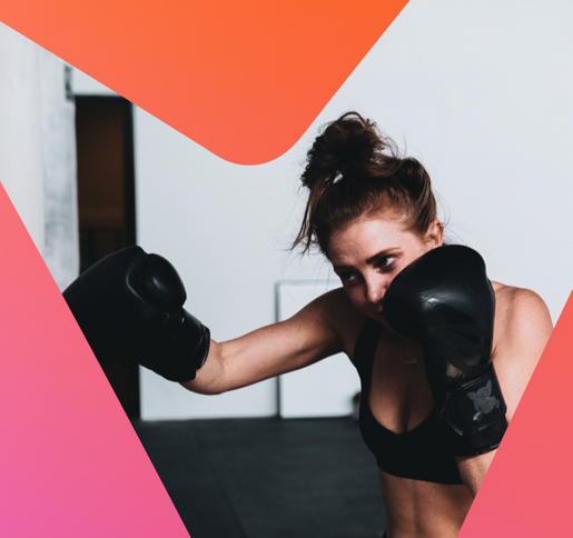 women shadow boxing with black boxing gloves